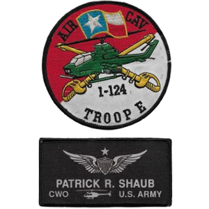 The pilot's jacket displaying authentic Texas Army National Guard patches. The red-and-white Troop E, 1st Squadron, 124th Cavalry Regiment patch belongs on the right breast, while the name patch belongs on the left.