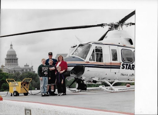 The author and his family standing in front of a Bell 412 air ambulance helicopter at the Texas State Capitol in Austin.